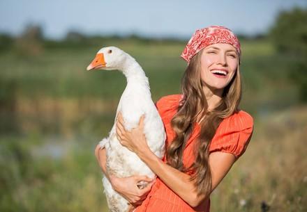 Woman holding a goose