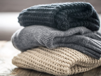 Stack of wool knit sweaters